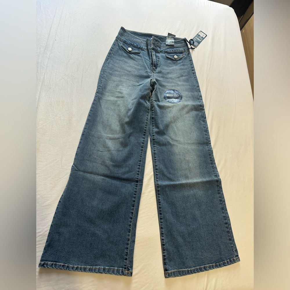 Blue flare jeans with distressed details and a wide leg fit #flarejeans